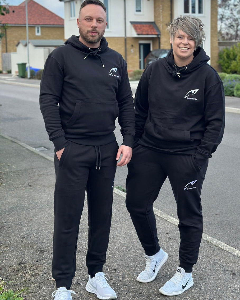 ROARFORM™ performance hoodie and joggers set in black worn outdoors, showing full outfit fit.